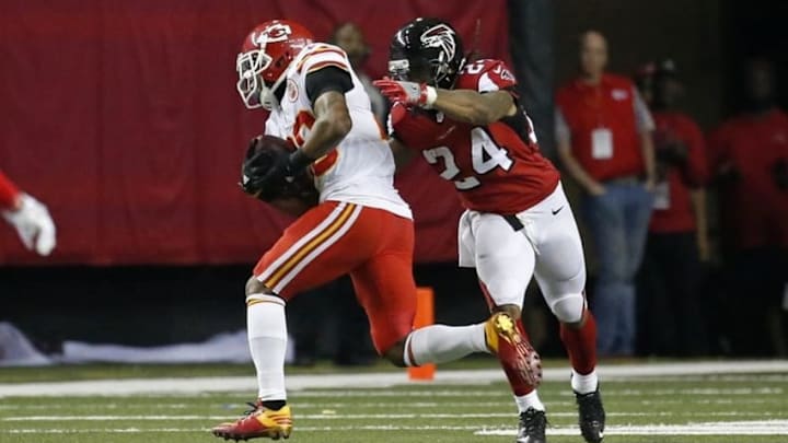 Dec 4, 2016; Atlanta, GA, USA; Kansas City Chiefs strong safety Eric Berry (29) carries the ball past Atlanta Falcons running back Devonta Freeman (24) to score a touchdown after an interception from quarterback Matt Ryan (not pictured) in the second quarter of their game at the Georgia Dome. Mandatory Credit: Jason Getz-USA TODAY Sports