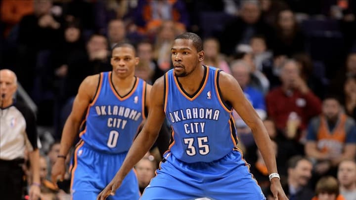Jan. 14, 2013; Phoenix, AZ, USA; Oklahoma City Thunder forward Kevin Durant (35) and guard Russell Westbrook (0) play defense in the game against the Phoenix Suns at the US Airways Center. The Thunder defeated the Suns 102-90. Mandatory Credit: Jennifer Stewart-USA TODAY Sports