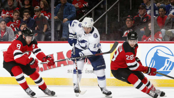 NEWARK, NJ - MARCH 24: Chris Kunitz #14 of the Tampa Bay Lightning battles for the puck between Damon Severson #28 of the New Jersey Devils and Taylor Hall #9 of the New Jersey Devils during the third period at the Prudential Center on March 24, 2018 in Newark, New Jersey. The Devils won 2-1. (Photo by Adam Hunger/Getty Images)