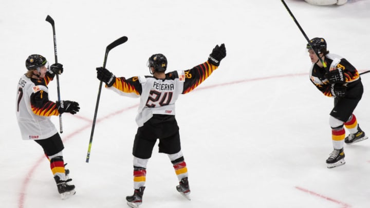 EDMONTON, AB - DECEMBER 26: Florian Elias #7, John Peterka #24 and Tim Stutzle #8 of Germany celebrate a goal against Canada during the 2021 IIHF World Junior Championship at Rogers Place on December 26, 2020 in Edmonton, Canada. (Photo by Codie McLachlan/Getty Images)