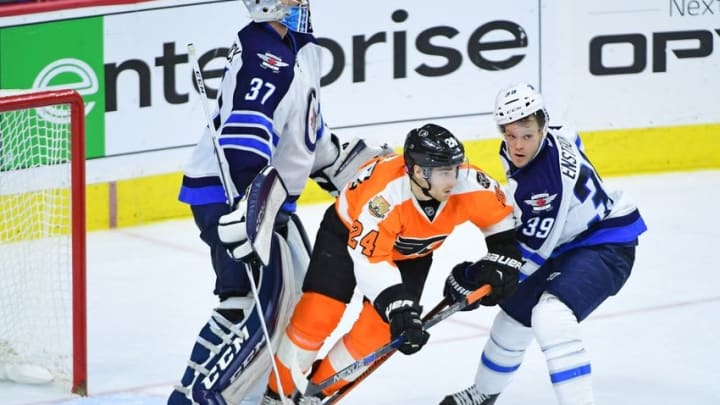 Nov 17, 2016; Philadelphia, PA, USA; Philadelphia Flyers right wing Matt Read (24) battles with Winnipeg Jets defenseman Toby Enstrom (39) in front of goalie Connor Hellebuyck (37) during the third period at Wells Fargo Center. The Flyers defeated the Jets, 5-2. Mandatory Credit: Eric Hartline-USA TODAY Sports