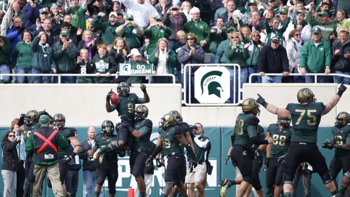 EAST LANSING, MI – OCTOBER 15: Isaiah Lewis #9 of the Michigan State Spartans celebrates a 39 yard touchdown after intercepting a pass from Denard Robinson #9 of the Michigan Wolverines in the fourth quarter of the game at Spartan Stadium on October 15, 2011 in East Lansing, Michigan. Michigan State defeated Michigan 28-14. (Photo by Leon Halip/Getty Images)