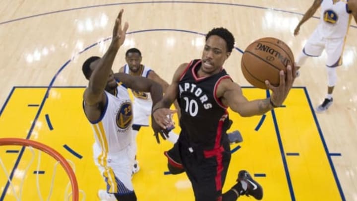 December 28, 2016; Oakland, CA, USA; Toronto Raptors guard DeMar DeRozan (10) shoots the basketball against Golden State Warriors forward Draymond Green (23) during the second half at Oracle Arena. The Warriors defeated the Raptors 121-111. Mandatory Credit: Kyle Terada-USA TODAY Sports