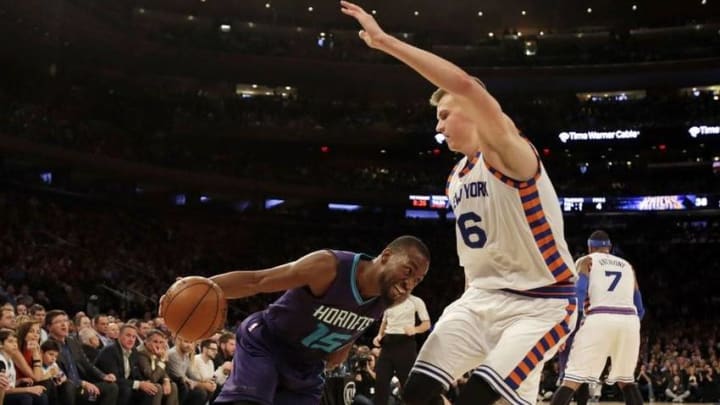 Nov 17, 2015; New York, NY, USA; Charlotte Hornets guard Kemba Walker (15) dribbles the ball as New York Knicks forward Kristaps Porzingis (6) defends during the first half at Madison Square Garden. Mandatory Credit: Adam Hunger-USA TODAY Sports