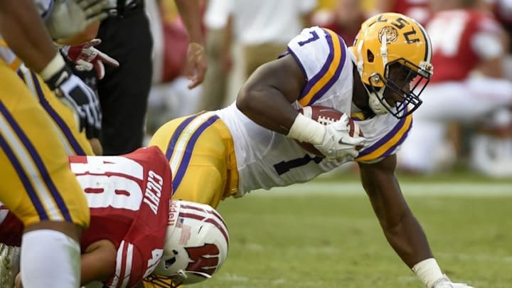 Sep 3, 2016; Green Bay, WI, USA; LSU running back Leonard Fournette (right) tries to break a tackle from Wisconsin linebacker Jack Cichy in the 2nd quarter at Lambeau Field. Mandatory Credit: Benny Sieu-USA TODAY Sports