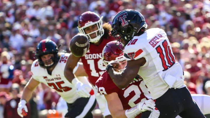 Oct 30, 2021; Norman, Oklahoma, USA; Oklahoma Sooners linebacker Danny Stutsman (28) causes Texas Tech Red Raiders wide receiver Kaylon Geiger (10) to fumble during the first half at Gaylord Family-Oklahoma Memorial Stadium. Mandatory Credit: Kevin Jairaj-USA TODAY Sports