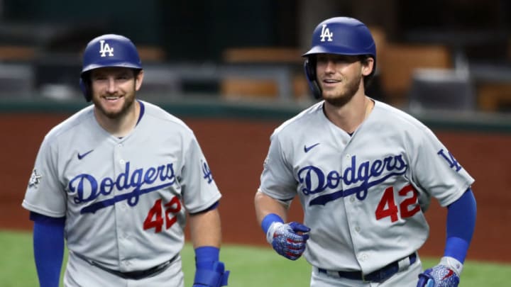 ARLINGTON, TEXAS - AUGUST 30: Cody Bellinger #35 of the Los Angeles Dodgers, right celebrates a two-run homerun with Max Muncy #13 against the Texas Rangers in the third inning at Globe Life Field on August 30, 2020 in Arlington, Texas. All players are wearing #42 in honor of Jackie Robinson Day. The day honoring Jackie Robinson, traditionally held on April 15, was rescheduled due to the COVID-19 pandemic. (Photo by Ronald Martinez/Getty Images)