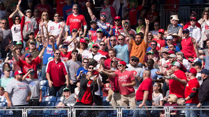 PHILADELPHIA, PA - APRIL 23: Fans try to catch the two run home run ball hit by Cesar Hernandez