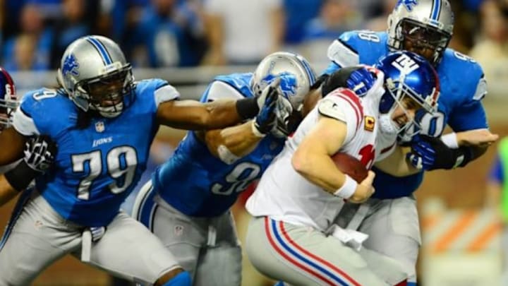 Dec 22, 2013; Detroit, MI, USA; New York Giants quarterback Eli Manning (10) is sacked by Detroit Lions defensive tackle Nick Fairley (98) in the end zone for a safety during the third quarter at Ford Field. Mandatory Credit: Andrew Weber-USA TODAY Sports