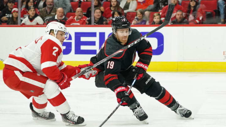 RALEIGH, NC - NOVEMBER 01: Carolina Hurricanes Defenceman Dougie Hamilton (19) tries to get a shot off in front of Detroit Red Wings Defenceman Joe Hicketts (2) during a game between the Detroit Red Wings and the Carolina Hurricanes on November 1, 2019 at the PNC Arena in Raleigh, NC. (Photo by Greg Thompson/Icon Sportswire via Getty Images)