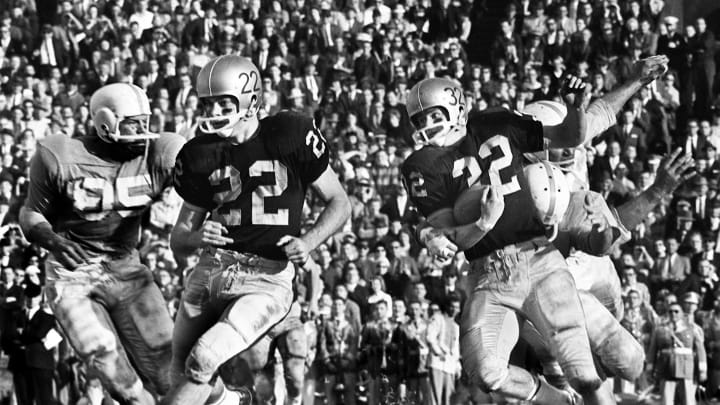 Vanderbilt halfback Jeff Starling (32) has a couple of Tennessee defenders on his back as he follows teammate Matt Howard (22). The Vols piled up 28 points after intermission for a 35-0 win over the Commodores at Dudley Field Nov. 26, 1960.