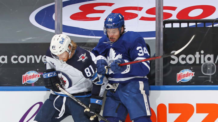 TORONTO, ON - JANUARY 18: Kyle Connor #81 of the Winnipeg Jets battles for the puck against Auston Matthews #34 of the Toronto Maple Leafs during an NHL game at Scotiabank Arena on January 18. 2021 in Toronto, Ontario, Canada. The Maple Leafs defeated the Jets 3-1. (Photo by Claus Andersen/Getty Images)
