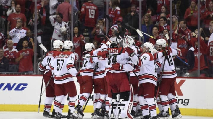 WASHINGTON, DC - APRIL 24: Brock McGinn #23 of the Carolina Hurricanes celebrates with his teammates after scoring the game winning goal in the second overtime period against the Washington Capitals in Game Seven of the Eastern Conference First Round during the 2019 NHL Stanley Cup Playoffs at Capital One Arena on April 24, 2019 in Washington, DC. The Hurricanes defeated the Capitals 4-3 in the second overtime period to move on to Round Two of the Stanley Cup playoffs. (Photo by Patrick McDermott/NHLI via Getty Images)