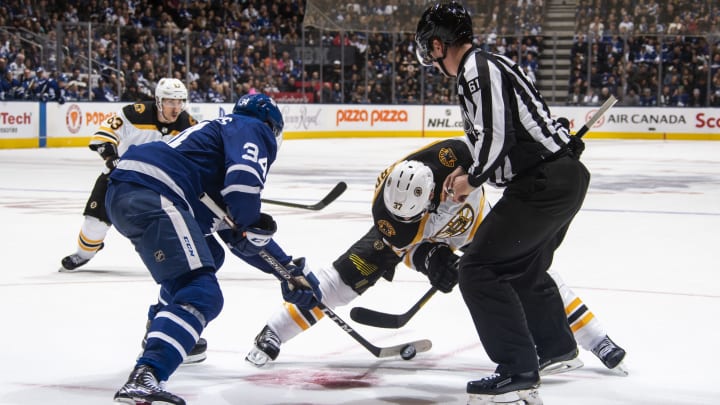 TORONTO, ON - OCTOBER 19: Patrice Bergeron #37 of the Boston Bruins takes a face-off against Auston Matthews #34 of the Toronto Maple Leafs during the second period at the Scotiabank Arena on October 19, 2019 in Toronto, Ontario, Canada. (Photo by Mark Blinch/NHLI via Getty Images)
