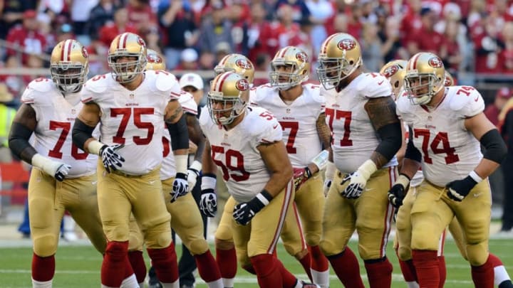 GLENDALE, AZ - DECEMBER 29: Anthony Davis #76, Alex Boone #75, Jonathan Goodwin #59, Mike Iupati #77, Joe Staley #74 and Colin Kaepernick #7 of the San Francisco 49ers run up to the line of scrimmage against the Arizona Cardinals at University of Phoenix Stadium on December 29, 2013 in Glendale, Arizona. (Photo by Norm Hall/Getty Images)