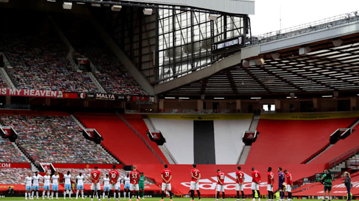MANCHESTER, ENGLAND - JULY 22: Players of both teams participate in a minute's silence in memory of Alex Dawson, Ex-Manchester United player prior to the Premier League match between Manchester United and West Ham United at Old Trafford on July 22, 2020 in Manchester, England. Football Stadiums around Europe remain empty due to the Coronavirus Pandemic as Government social distancing laws prohibit fans inside venues resulting in all fixtures being played behind closed doors. (Photo by Catherine Ivill/Getty Images)
