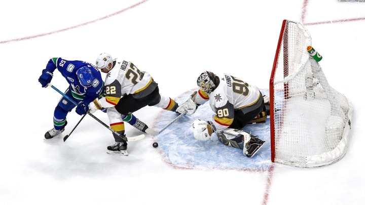Nick Holden #22 and Robin Lehner #90 of the Vegas Golden Knights defend the goal against Bo Horvat #53 of the Vancouver Canucks
