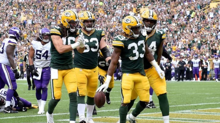 GREEN BAY, WISCONSIN - SEPTEMBER 15: Aaron Jones #33 of the Green Bay Packers celebrates with teammates after scoring a touchdown in the second quarter against the Minnesota Vikings at Lambeau Field on September 15, 2019 in Green Bay, Wisconsin. (Photo by Quinn Harris/Getty Images)