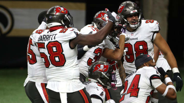 NEW ORLEANS, LOUISIANA - JANUARY 17: Mike Edwards #32 of the Tampa Bay Buccaneers celebrates with his teammates after intercepting a pass thrown by Drew Brees #9 of the New Orleans Saints during the fourth quarter in the NFC Divisional Playoff game at Mercedes Benz Superdome on January 17, 2021 in New Orleans, Louisiana. (Photo by Chris Graythen/Getty Images)