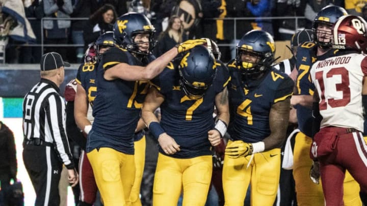 MORGANTOWN, WV – NOVEMBER 23: West Virginia Mountaineers Wide Receiver David Sills V (13) and West Virginia Mountaineers Running Back Leddie Brown (4) congratulate West Virginia Mountaineers Quarterback Will Grier (7) after scoring a touchdown during the second half of the Oklahoma Sooners versus the West Virginia Mountaineers game on November 23, 2018, at the Mountaineer Field at Milan Puskar Stadium in Morgantown, WV. (Photo by Gregory Fisher/Icon Sportswire via Getty Images)