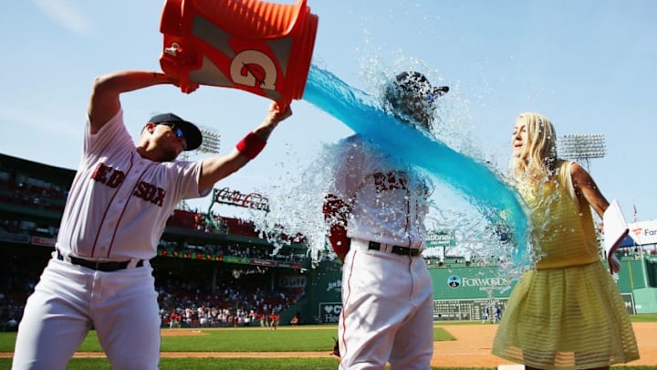 BOSTON, MA - MAY 02: Hector Velazquez #76 of the Boston Red Sox douses Mookie Betts #50 as he is interviewed after the Boston Red Sox defeated the Kansas City Royals 5-4 at Fenway Park on May 2, 2018 in Boston, Massachusetts. Betts hit 3 solo home runs. (Photo by Tim Bradbury/Getty Images)