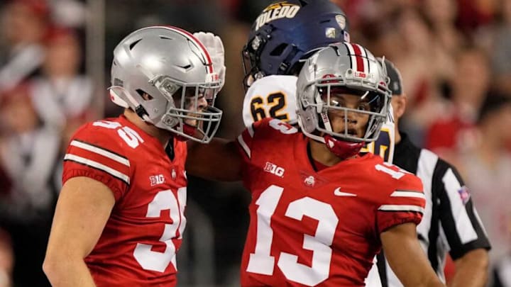 Sep 17, 2022; Columbus, Ohio, USA; Ohio State Buckeyes linebacker Tommy Eichenberg (35) and Ohio State Buckeyes safety Cameron Martinez (13) celebrate after a play that caused a fumble during Saturday's NCAA Division I football game against the Toledo Rockets at Ohio Stadium. Mandatory Credit: Barbara Perenic/Columbus DispatchNcaa Football Toledo Rockets At Ohio State Buckeyes Sep 17, 2022; Columbus, Ohio, USA; Ohio State Buckeyes linebacker Tommy Eichenberg (35) and Ohio State Buckeyes safety Cameron Martinez (13) celebrate after a play that caused a fumble during Saturday's NCAA Division I football game against the Toledo Rockets at Ohio Stadium. Mandatory Credit: Barbara Perenic/Columbus DispatchNcaa Football Toledo Rockets At Ohio State Buckeyes
