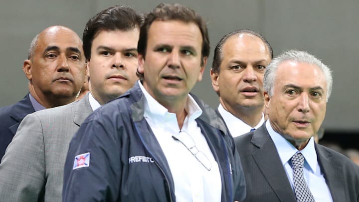 RIO DE JANEIRO, BRAZIL - JUNE 14: Rio de Janeiro's Mayor Eduardo Paes (C) stands with Brazil's interim President Michel Temer (R) and other officials during Temer's first visit to the Olympic Park on June 14, 2016 in Rio de Janeiro, Brazil. The Rio 2016 Olympic Games commence August 5 amidst a political and economic crisis in the country along with the Zika virus outbreak. (Photo by Mario Tama/Getty Images)