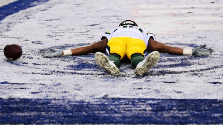 EAST RUTHERFORD, NEW JERSEY - DECEMBER 01: Aaron Jones #33 of the Green Bay Packers makes a snow angel in the second half of their game against the New York Giants at MetLife Stadium on December 01, 2019 in East Rutherford, New Jersey. (Photo by Emilee Chinn/Getty Images)
