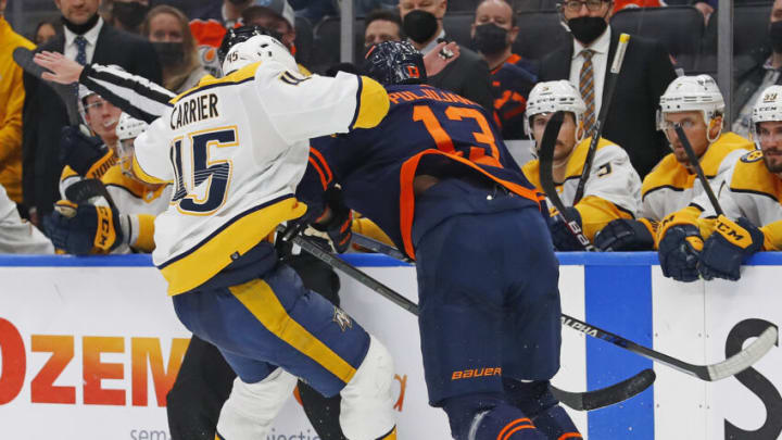 Edmonton Oilers forward Jesse Puljujarvi (13) hits Nashville Predators defensemen Alex Carrier (45) Mandatory Credit: Perry Nelson-USA TODAY Sports