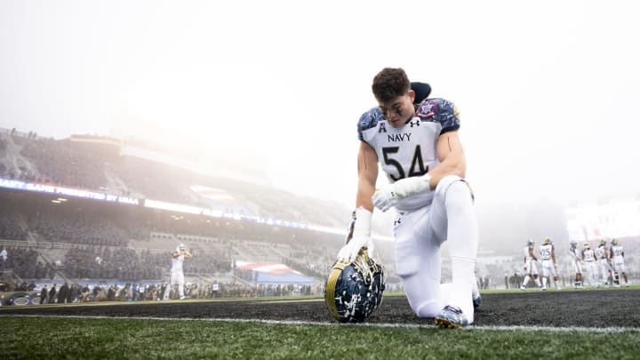 WEST POINT, NY – DECEMBER 12: Diego Fagot #54 of the Navy Midshipmen kneels in the end zone before the start of a game against the Army Black Knights at Michie Stadium on December 12, 2020 in West Point, New York. (Photo by Dustin Satloff/Getty Images)