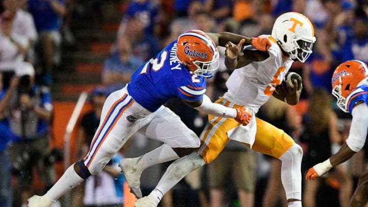 Tennessee quarterback Hendon Hooker (5) evades Florida linebacker Amari Burney (2) during a game at Ben Hill Griffin Stadium in Gainesville, Fla. on Saturday, Sept. 25, 2021.Kns Tennessee Florida Football