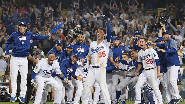 LOS ANGELES, CA - OCTOBER 26: The Los Angeles Dodgers await to congratulate Max Muncy #13 at home plate after his eighteenth inning walk-off home run to defeat the the Boston Red Sox 3-2 in Game Three of the 2018 World Series at Dodger Stadium on October 26, 2018 in Los Angeles, California. (Photo by Harry How/Getty Images)