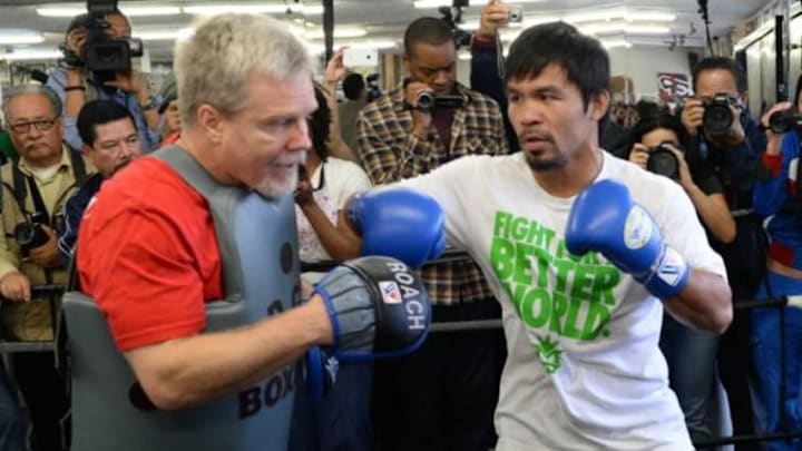 Apr 2, 2014; Hollywood, CA, USA; Manny Pacquiao spars with trainer Freddie Roach during his workout at Wild Card Boxing Club. Mandatory Credit: Jayne Kamin-Oncea-USA TODAY Sports Apr 2, 2014; Hollywood, CA, USA; Manny Pacquiao spars with trainer Freddie Roach during his workout at Wild Card Boxing Club. Mandatory Credit: Jayne Kamin-Oncea-USA TODAY Sports