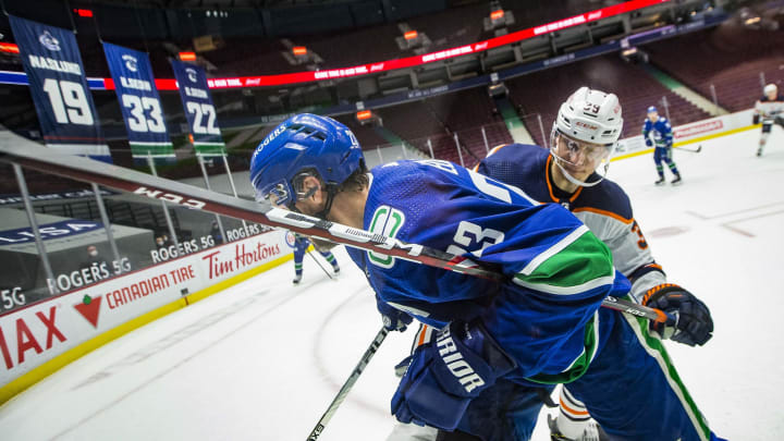 May 3, 2021; Vancouver, British Columbia, CAN; Edmonton Oilers forward Alex Chiasson (39) checks Vancouver Canucks defenseman Alexander Edler (23) in the third period at Rogers Arena. Oilers won 5-3. Mandatory Credit: Bob Frid-USA TODAY Sports