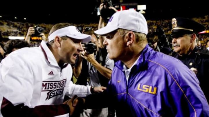 November 10, 2012; Baton Rouge, LA, USA; LSU Tigers head coach Les Miles and Mississippi State Bulldogs head coach Dan Mullen meet following a game at Tiger Stadium. LSU defeated Mississippi State 37-17. Mandatory Credit: Derick E. Hingle-USA TODAY Sports