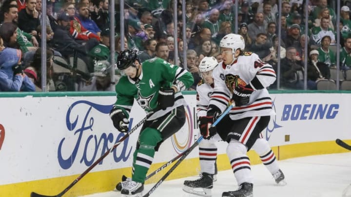 DALLAS, TX - DECEMBER 20: Dallas Stars defenseman John Klingberg (3) and Chicago Blackhawks right wing John Hayden (40) battle for the puck during the game between the Dallas Stars and the Chicago Blackhawks on December 20, 2018 at the American Airlines Center in Dallas, Texas. (Photo by Matthew Pearce/Icon Sportswire via Getty Images)