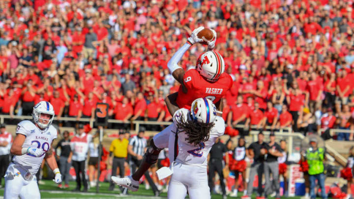 LUBBOCK, TX - OCTOBER 20: T.J. Vasher #9 of the Texas Tech Red Raiders makes the catch for a touchdown against Corione Harris #2 of the Kansas Jayhawks during the first half of the game on October 20, 2018 at Jones AT&T Stadium in Lubbock, Texas. (Photo by John Weast/Getty Images)