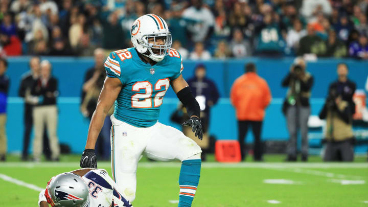 MIAMI GARDENS, FL – DECEMBER 11: T.J. McDonald #22 of the Miami Dolphins reacts after stopping Dion Lewis #33 of the New England Patriots in the third quarter at Hard Rock Stadium on December 11, 2017 in Miami Gardens, Florida. (Photo by Mike Ehrmann/Getty Images)