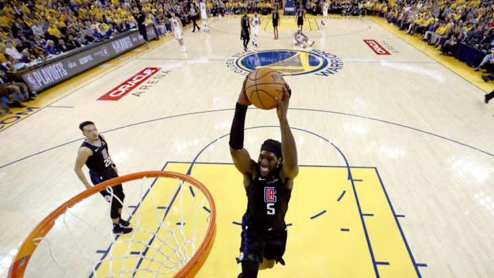 OAKLAND, CALIFORNIA - APRIL 13: Montrezl Harrell #5 of the LA Clippers goes up for a dunk against the Golden State Warriors during Game One of the first round of the 2019 NBA Western Conference Playoffs at ORACLE Arena on April 13, 2019 in Oakland, California. NOTE TO USER: User expressly acknowledges and agrees that, by downloading and or using this photograph, User is consenting to the terms and conditions of the Getty Images License Agreement. (Photo by Ezra Shaw/Getty Images)