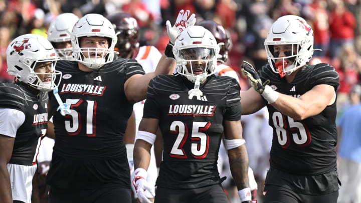 Nov 4, 2023; Louisville, Kentucky, USA; /Louisville Cardinals running back Jawhar Jordan (25) is congratulated by teammates after scoring a touchdown against the Virginia Tech Hokies during the first quarter at L&N Federal Credit Union Stadium. Mandatory Credit: Jamie Rhodes-USA TODAY Sports