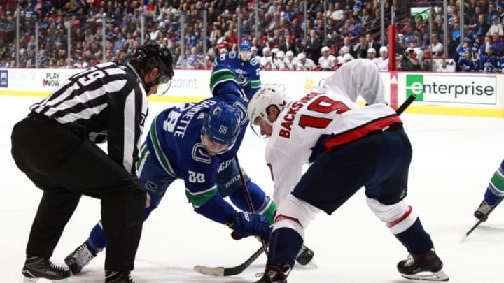 VANCOUVER, BC - OCTOBER 22: Adam Gaudette #88 of the Vancouver Canucks and Nicklas Backstrom #19 of the Washington Capitals face-off during their NHL game at Rogers Arena October 22, 2018 in Vancouver, British Columbia, Canada. (Photo by Jeff Vinnick/NHLI via Getty Images)"n