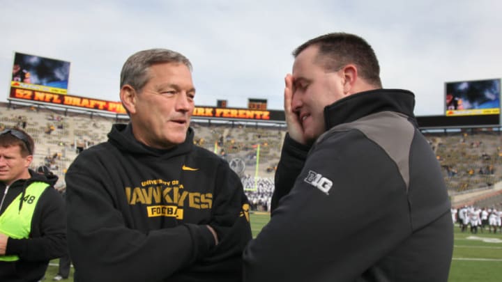 IOWA CITY, IOWA - OCTOBER 26: Head coach Kirk Ferentz of the Iowa Hawkeyes visits with head coach Pat Fitzgerald of the Northwestern Wildcats prior to their match-up on October 26, 2013 at Kinnick Stadium in Iowa City, Iowa. (Photo by Matthew Holst/Getty Images)
