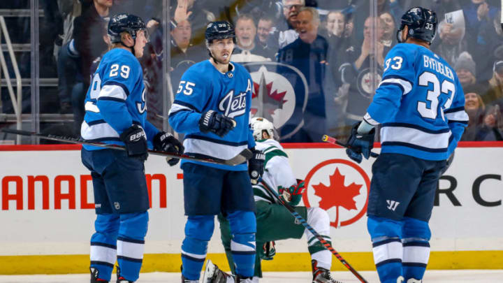 WINNIPEG, MB - DECEMBER 29: Patrik Laine #29, Mark Scheifele #55 and Dustin Byfuglien #33 of the Winnipeg Jets celebrate a third period goal against the Minnesota Wild at the Bell MTS Place on December 29, 2018 in Winnipeg, Manitoba, Canada. (Photo by Jonathan Kozub/NHLI via Getty Images)