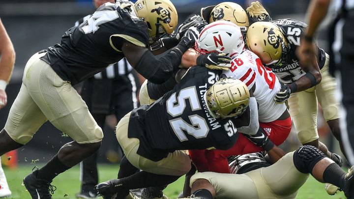 BOULDER, CO - SEPTEMBER 7: Running back Maurice Washington #28 of the Nebraska Cornhuskers is tackled by a group of Colorado Buffaloes defensive players including linebacker Alex Tchangam #52 in the second half of a game at Folsom Field on September 7, 2019 in Boulder, Colorado. (Photo by Dustin Bradford/Getty Images)