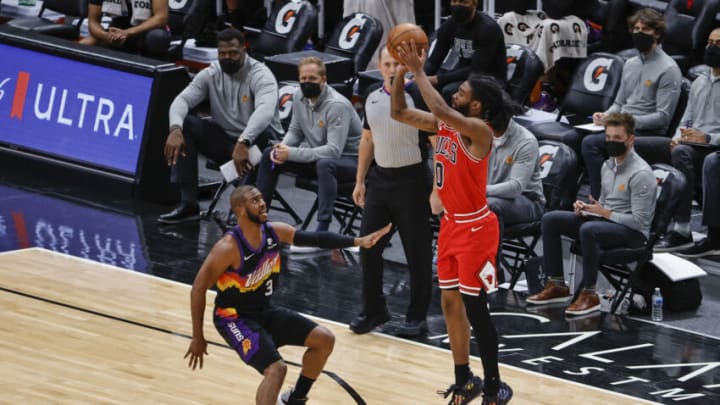 Feb 26, 2021; Chicago, Illinois, USA; Chicago Bulls guard Coby White (0) shoots against Phoenix Suns guard Chris Paul (3) during the first half of an NBA game at United Center. Mandatory Credit: Kamil Krzaczynski-USA TODAY Sports