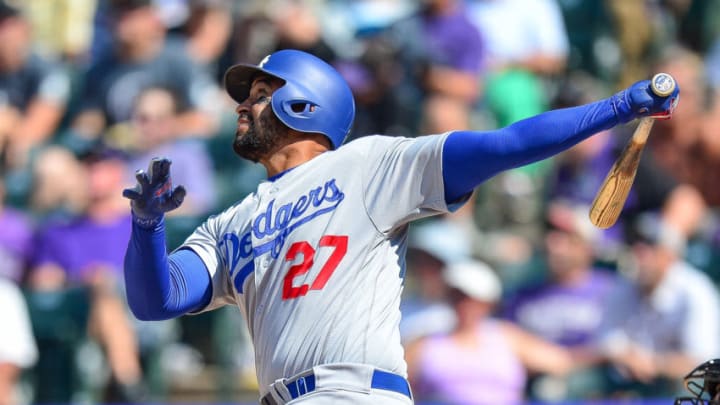 DENVER, CO - AUGUST 12: Matt Kemp #27 of the Los Angeles Dodgers hits a game-tying RBI sacrifice fly in the top of the eighth inning of a game against the Colorado Rockies at Coors Field on August 12, 2018 in Denver, Colorado. (Photo by Dustin Bradford/Getty Images)