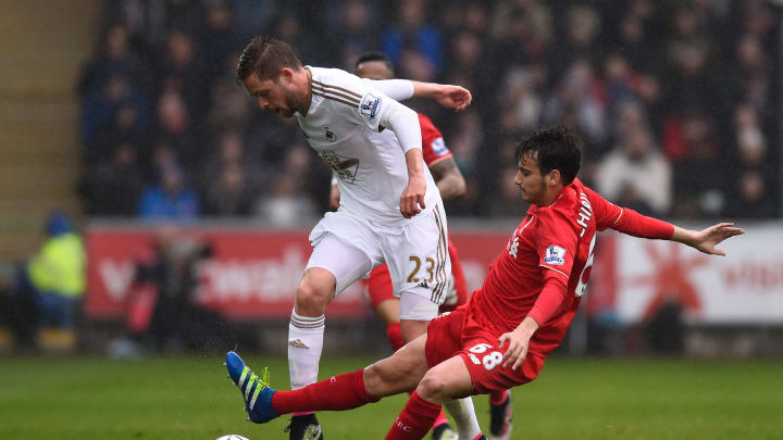 SWANSEA, WALES – MAY 01: Gylfi Sigurdsson of Swansea City is tackled by Pedro Chirivella of Liverpool during the Barclays Premier League match between Swansea City and Liverpool at The Liberty Stadium on May 1, 2016 in Swansea, Wales. (Photo by Stu Forster/Getty Images)