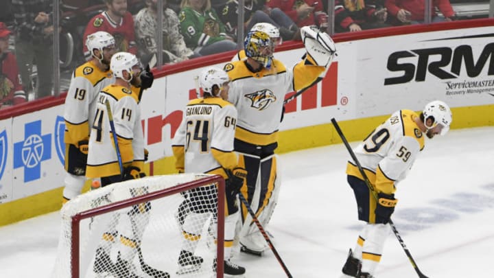 Jan 9, 2020; Chicago, Illinois, USA; Nashville Predators goaltender Pekka Rinne (35) celebrates after scoring a empty net goal against the Chicago Blackhawks with his teammates during the third period at United Center. Mandatory Credit: David Banks-USA TODAY Sports