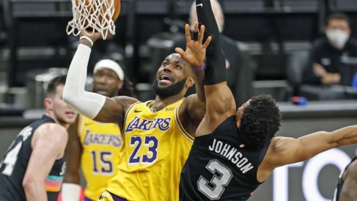 SAN ANTONIO, TX - JANUARY 1: LeBron James #23 of the Los Angeles Lakers drives past Keldon Johnson #3 of the San Antonio Spurs #3 during second half action at AT&T Center on January 1 , 2021 in San Antonio, Texas. NOTE TO USER: User expressly acknowledges and agrees that , by downloading and or using this photograph, User is consenting to the terms and conditions of the Getty Images License Agreement. (Photo by Ronald Cortes/Getty Images)