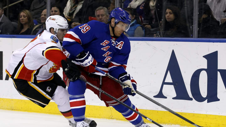 Dec 15, 2013; New York, NY, USA; New York Rangers center Brad Richards (19) fights for control of the puck with Calgary Flames defenseman Ladislav Smid (3) during the second period at Madison Square Garden. Mandatory Credit: Adam Hunger-USA TODAY Sports